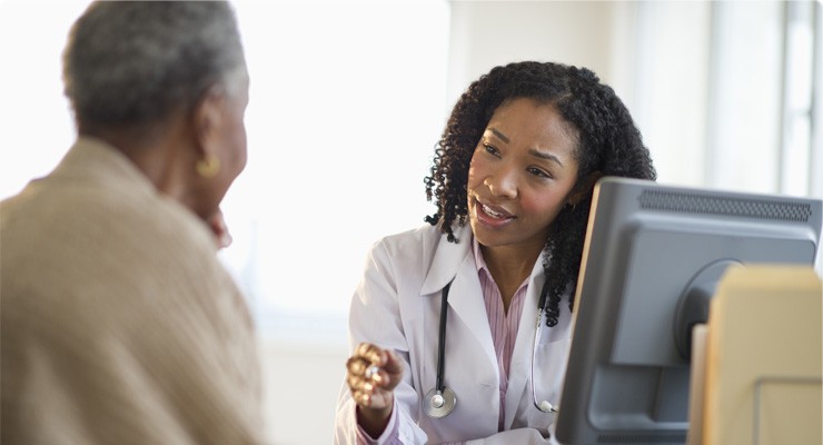 doctor talking to an older female patient