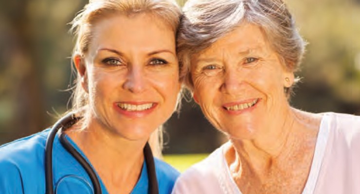 patient and nurse outside smiling.