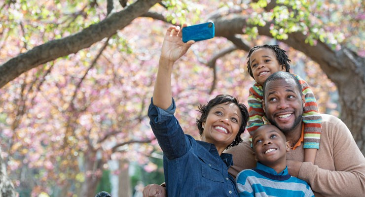 family taking a selfie in the park
