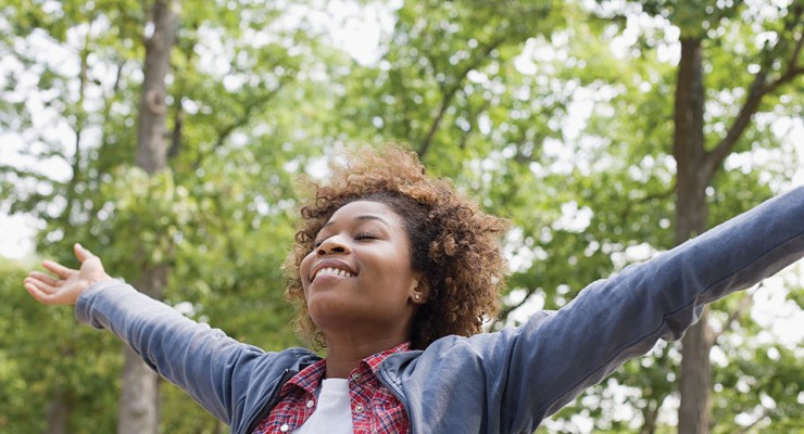 woman outside with arms outstretched