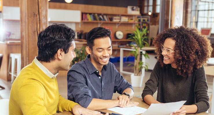 group of three talking around table